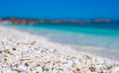 Fototapeta na wymiar Stack of small white stones on tropical pebbles beach