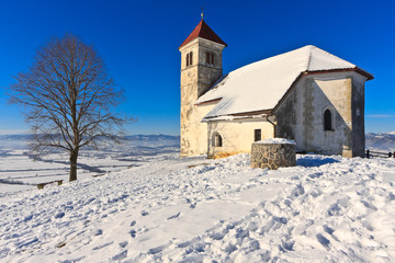 Fototapeta na wymiar St. Ana church on a snowy hill in winter