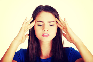 Obraz premium Young casual woman is touching her temples.