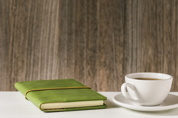Notebook and Coffee cup on Desk.