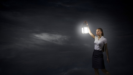 Businesswoman with lantern