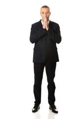 Full length businessman with clenched hands