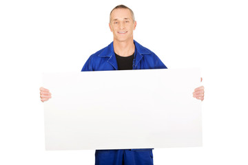Happy worker presenting empty banner