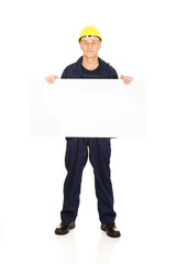 Full length happy worker presenting empty banner