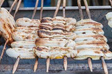 Grilled banana skewers on stove in market. Thailand dessert.