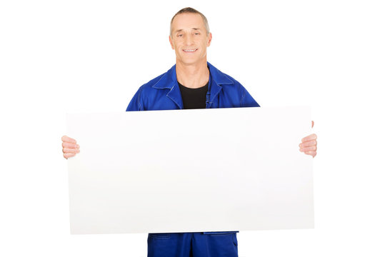 Happy worker presenting empty banner