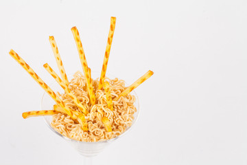 Pretzel snacks in glass over white background.