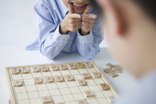 Boy playing with happily Shogi
