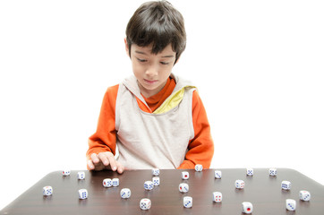 Little boy playing with dice