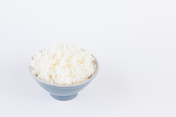 Bowl full of rice on white paper background