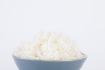 Bowl full of rice on white paper background