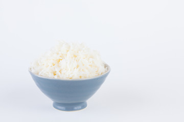 Bowl full of rice on white paper background