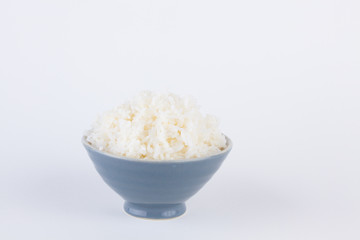 Bowl full of rice on white paper background