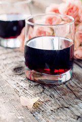 Glass of Red Wine and Pink Roses