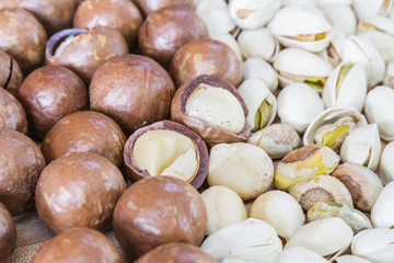 Macadamia and Pistachio nut on wood table.