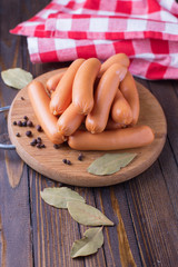 Tasty sausages on wooden board