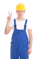 young handsome man in blue builder uniform showing victory sign