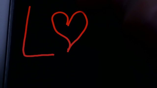 LOVE written on the screen of a smartphone made by hand