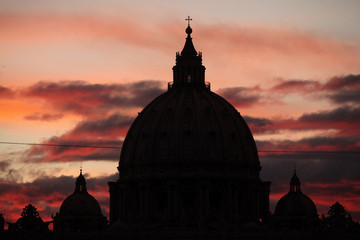 Sunset over the dome of Saint Peter's Basilica in Vatican City.