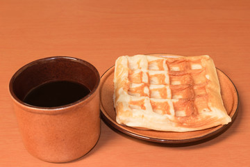 cup of coffee and waffle on the dish