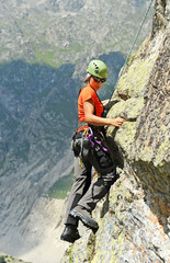 Fototapeta premium The rock-climber during rock conquest