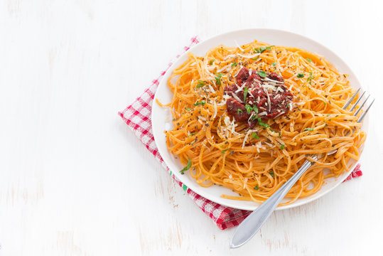 pasta with tomato sauce and parmesan on white wooden backgroun