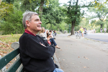 Retired Senior Man at Park, Seated on a Bench
