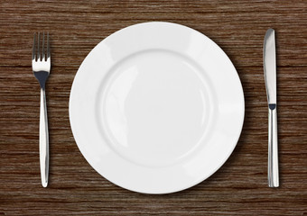 white empty dinner plate setting on dark wooden table