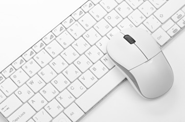 White computer mouse on the keyboard