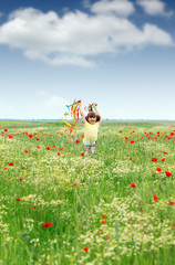 happy little girl running in the spring meadow