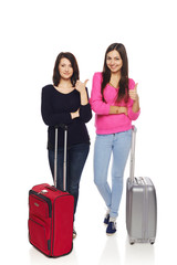 Two friends girls with travel suitcases