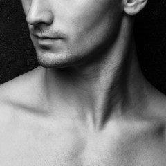 Male beauty concept. Half-face portrait of muscle young man posi