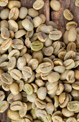 green coffee beans on wooden surface