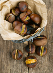 roasted chestnuts on wooden surface