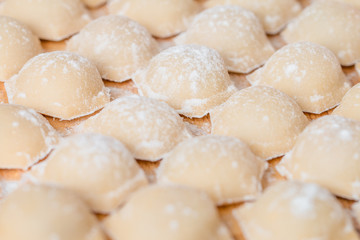 Fototapeta na wymiar Homemade raw pastry dumplings with meat filling called pelmeni