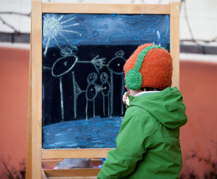 Adorable Little Boy, Drawing Summer Picture With Chalk On A Boar