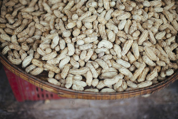 Whole peanuts in a bowl on market.