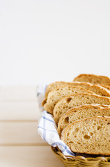 pieces of fresh homemade bread on a white towel in basket