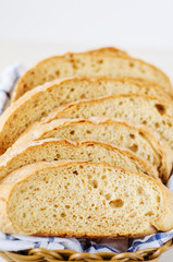 pieces of fresh homemade bread on a white towel in basket
