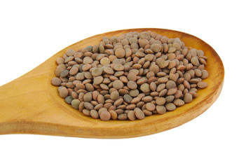Closup of lentils with wooden spoon isolated on white.