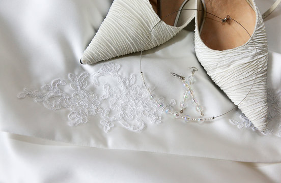 Elegant bridal shoes and jewelryon wedding dress