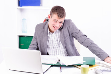 Young and handsome businessman speaking on the mobile phone