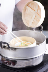 Chef cooking dumpling with streamed pot