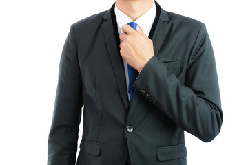 Businessman adjusting necktie isolated
