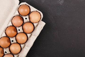 Eggs on dark chalkboard with copy-space