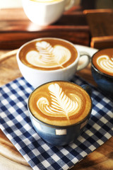 vintage color tone of  cup of coffee with red heart on the table