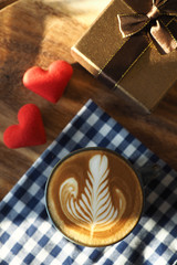 vintage color tone of  cup of coffee with red heart on the table