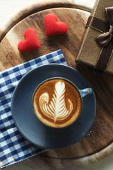 vintage color tone of  cup of coffee with red heart on the table