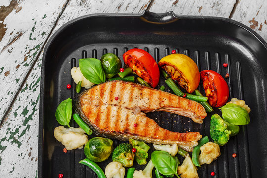 grilled salmon with vegetables on a grill pan