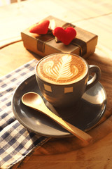vintage color tone of  cup of coffee with red heart on the table